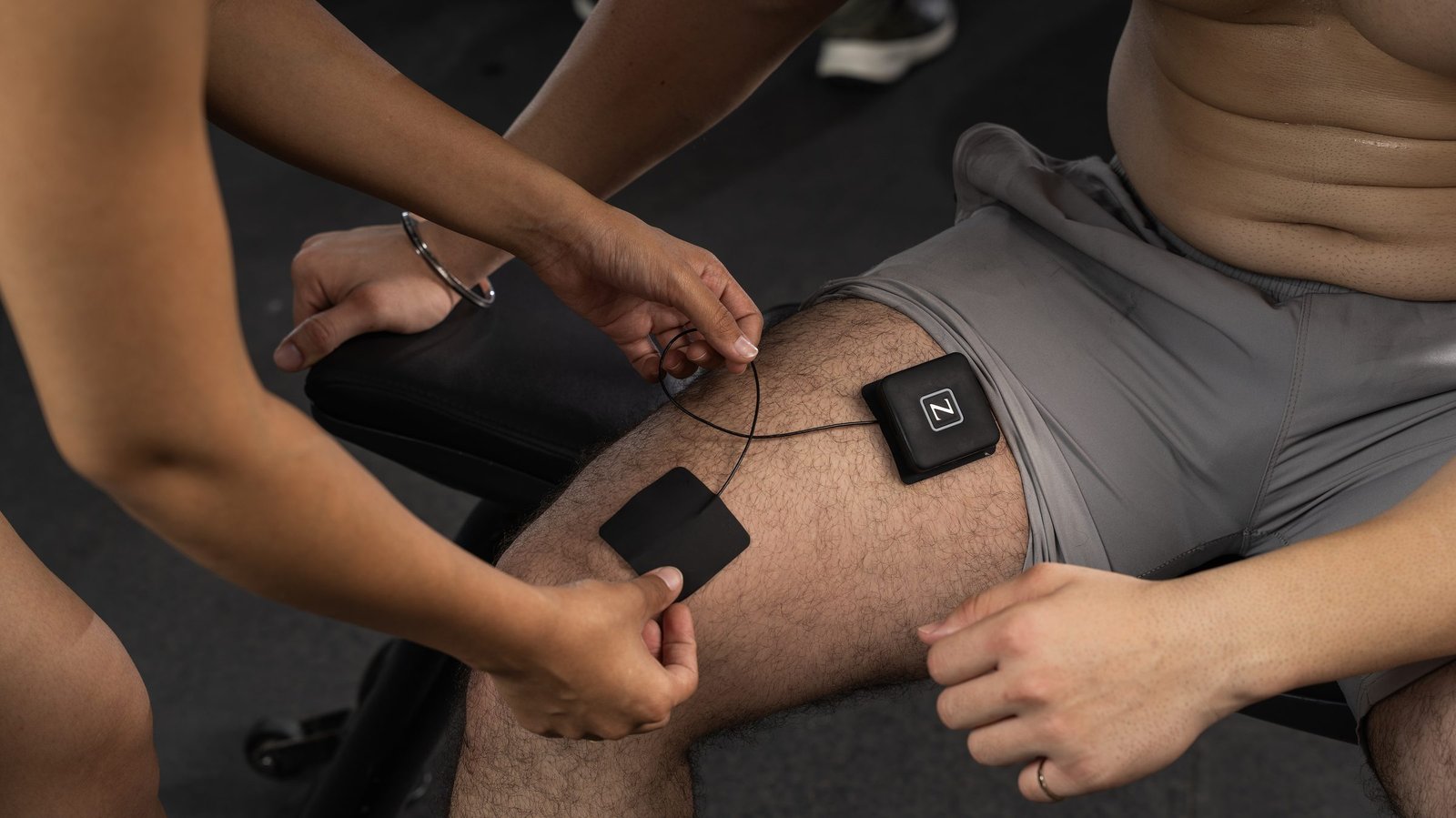 A pod and spot pads being fitted to the thigh